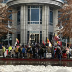 
              Dozens of tribe members and other protesters beating drums and waving signs rally in front of the federal courthouse in Reno, Nev. Thursday, Jan. 5, 2023, as a court hearing began over a lawsuit seeking to block a huge lithium mine planned near the Nevada-Oregon line about 200 miles north of Reno. (AP Photo/Scott Sonner)
            