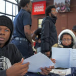 
              Schoolmates Kheyon Martin, 17 and Ayauhna Stewart, 15, right, look over documents before interacting with jobs recruiters at UA House/Living Classrooms as city leaders, representatives from the Mayor's Office of African American Male Engagement and Downtown Partnership of Baltimore, squeegee workers and community members, attends a resource and hiring event for squeegee workers prior to the enforcement of "disallowed zones" Friday, Jan. 6, 2023, in Baltimore. (Karl Merton Ferron/The Baltimore Sun via AP)
            