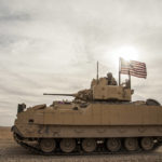 
              FILE - American soldiers drive a Bradley fighting vehicle during a joint exercise with Syrian Democratic Forces at the countryside of Deir Ezzor in northeastern Syria, Dec. 8, 2021. The U.S. and Germany are sending Ukraine an array of armored vehicles, including 50 tank-killing Bradleys, to expand its ability to move troops to the front lines and beef up its forces against Russia as the war nears its first anniversary. (AP Photo/Baderkhan Ahmad, File)
            