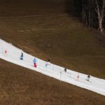 
              People skiing on a slope in Filzmoos south of Salzburg, Austria, Thursday, Jan. 5, 2023. Sparse snowfall and unseasonably warm weather in much of Europe is allowing green grass to blanket many mountaintops across the region where snow might normally be. It has caused headaches for ski slope operators and aficionados of Alpine white this time of year. (AP Photo/Matthias Schrader)
            