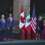 
              U.S. President Joe Biden, left, Mexican President Andrés Manuel López Obrador, second from left, and Canada's Prime Minister Justin Trudeau pose for an official photo as their wives stand to the side, before the start of a North America Summit at the National Palace in Mexico City, Tuesday, Jan. 10, 2023. The first ladies are, from left, Jill Biden, Beatriz Gutiérrez Müller and Sophie Grégoire Trudeau. (AP Photo/Fernando Llano)
            