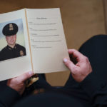 
              FILE - In this Feb. 3, 2021 photo, a U.S. Capitol Police Officer holds a program during a ceremony memorializing U.S. Capitol Police officer Brian Sicknick, as an urn with his cremated remains lies in honor on a black-draped table at the center of the Capitol Rotunda, in Washington. President Joe Biden on Friday, Jan. 6, 2023, will present the nation's second highest civilian to 12 individuals involved in defending the Capitol during the insurrection on Jan. 6, 2021, and safeguarding the will of American voters in the 2020 presidential election, including a posthumous award to Sicknick. (Demetrius Freeman/The Washington Post via AP, Pool)
            