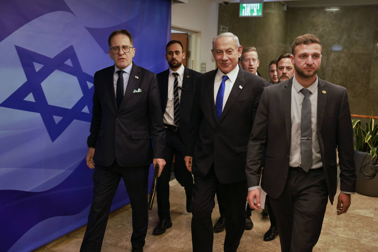 Israeli Prime Minister Benjamin Netanyahu, center, arrives for a weekly cabinet meeting at the Prim...