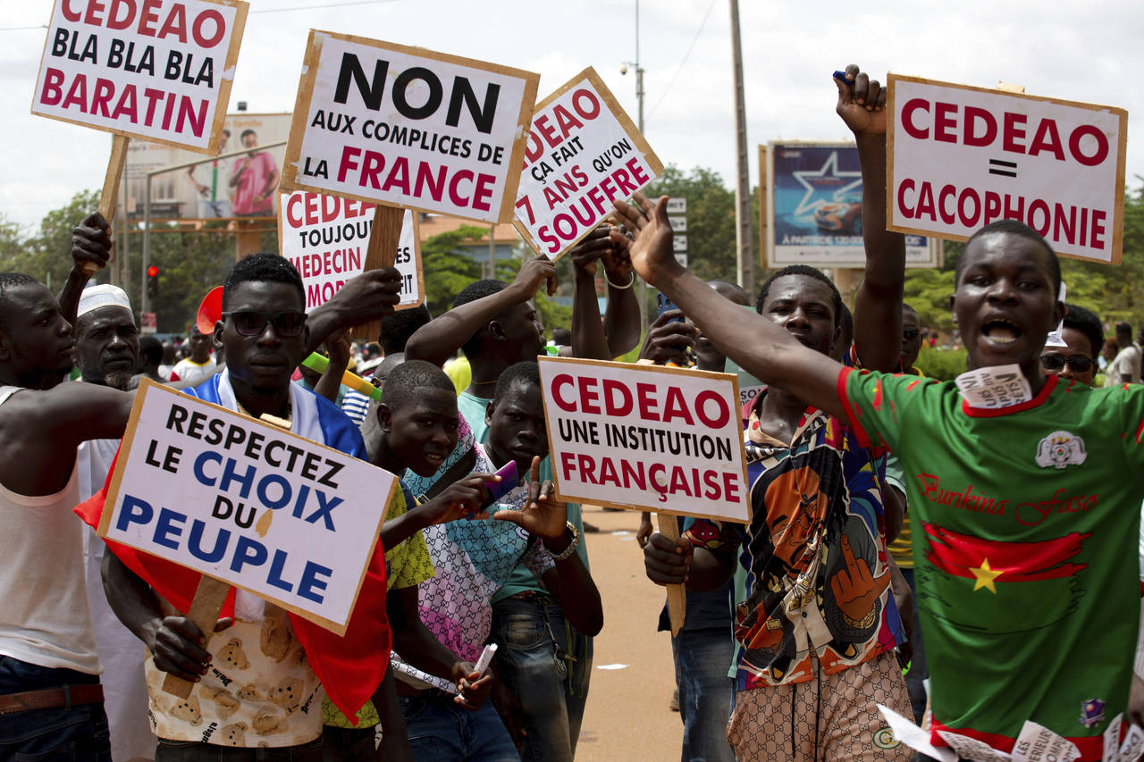 FILE - Supporters of Capt. Ibrahim Traore protest against France and the West African regional bloc...