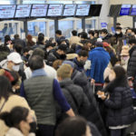 
              Passengers wait for their flight tickets at Jeju International Airport on Jeju Island, South Korea, Tuesday, Jan. 24, 2023. Thousands of travelers swarmed a small airport in South Korea's Jeju island on Wednesday in a scramble to get on flights following delays by snowstorms as frigid winter weather gripped East Asia for the second straight day. (Park Ji-ho/Yonhap via AP)
            