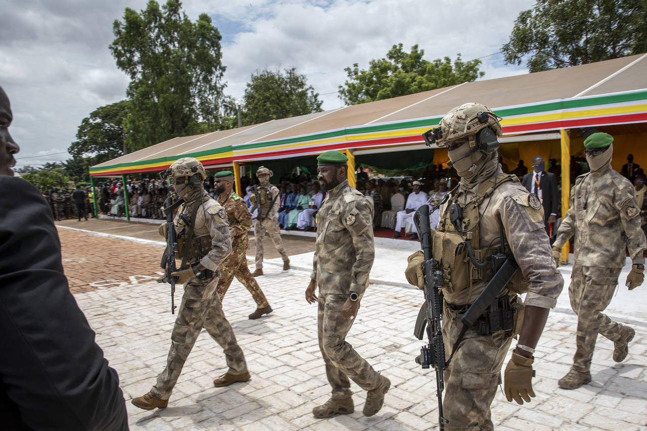 FILE - Leader of Mali's ruling junta Lt. Col. Assimi Goita, center, attends an independence day mil...