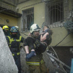 
              In this photo released by State Emergency Service of Ukraine on Monday, Jan. 16, 2022, a Ukrainian State Emergency Service firefighter carries a wounded woman out of the rubble from a building after a Russian rocket attack on Saturday in Dnipro, Ukraine, Sunday, Jan. 15, 2023. (Pavel Petrov, SESU via AP)
            