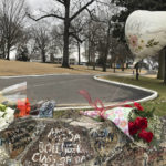 
              Bouquets of flowers and a balloon line the stone wall at Graceland on Friday, Jan. 13, 2023, in Memphis, Tenn. Lisa Marie Presley will be buried at Graceland, her father Elvis' mansion that on Friday was a gathering place for fans who were distraught over the singer-songwriter's death a day earlier. (AP Photo/Adrian Sainz)
            