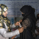 An Afghan woman is checked by a nutritionist at a clinic run by the WFP, in Kabul, Afghanistan, Thursday, Jan. 26, 2023. A spokesman for the U.N. food agency says malnutrition rates in Afghanistan are at record highs. Aid agencies have been providing food, education, healthcare and other critical support to people, but distribution has been severely impacted by a Taliban edict banning women from working at national and international nongovernmental groups. (AP Photo/Ebrahim Noroozi)