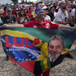 
              A supporter of Luiz Inacio Lula da Silva displays a banner during his inauguration as new president outside the Planalto presidential palace in Brasilia, Brazil, Sunday, Jan. 1, 2023. (AP Photo/Silvia Izquierdo)
            