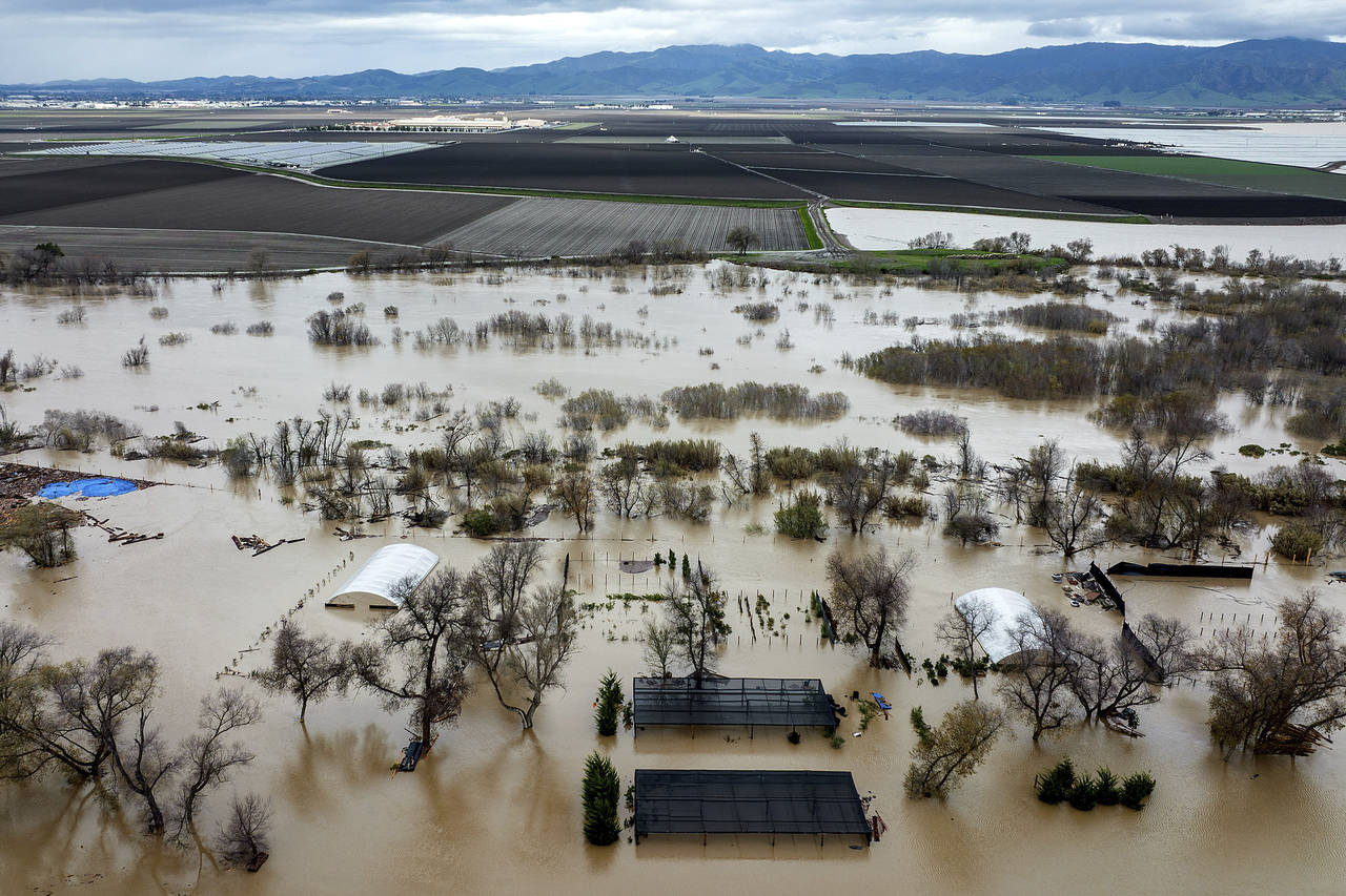 FILE - Floodwaters cover a property along River Rd. in Monterey County, Calif., as the Salinas Rive...