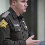 
              Vanderburgh County Sheriff Noah Robinson answers questions during a press conference, Friday afternoon, Jan. 20, 2023, related to the ongoing investigation of a shooting at the West Side Walmart in Evansville, Ind. Police identified the shooter, displayed on a monitor, as 25-year-old Ronald Ray Mosley II, a former Walmart employee who was charged with assaulting four people in the store last year. (MaCabe Brown/Evansville Courier & Press via AP)
            