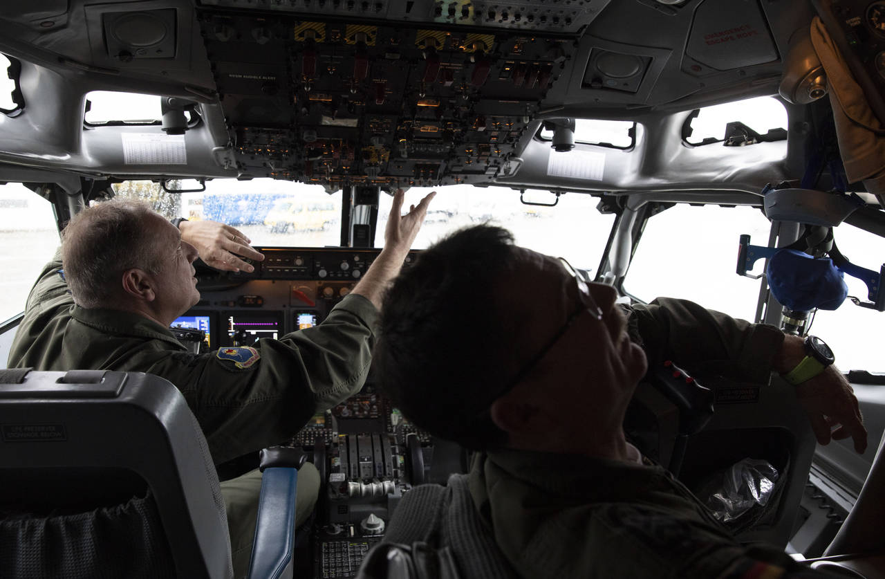 FILE - Pilots work in the cockpit of an AWACS plane at Melsbroek military airport in Melsbroek, Bel...