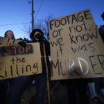 
              Protesters hold signs Friday, Jan. 27, 2023, in Memphis, Tenn., as authorities are set to release police video depicting five Memphis officers beating Tyre Nichols, whose death resulted in murder charges and provoked outrage at the country's latest instance of police brutality. (AP Photo/Gerald Herbert)
            