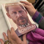 
              A woman holds a copy of "En La Sombra" (In the Shadow), the Spanish translation of Prince Harry's memoir, "Spare," in Barcelona, Spain, Thursday Jan. 5, 2023. Prince Harry alleges in a much-anticipated new memoir, due to be published next week, that his brother Prince William lashed out and physically attacked him during a furious argument over the brothers' deteriorating relationship. (AP Photo)
            