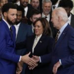 
              President Joe Biden shakes hands with Stephen Curry as Vice President Kamala Harris smiles as they welcome the 2022 NBA champions, the Golden State Warriors, to the East Room of the White House in Washington, Tuesday, Jan 17, 2023. (AP Photo/Susan Walsh)
            