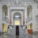 
              A police officer walks inside the Court of Appeal during the hearings of Andrew Tate, his brother Tristan and two other suspects in Bucharest, Romania, Tuesday, Jan.10, 2023. Andrew Tate, a divisive social media personality and former professional kickboxer, was detained last month in Romania on charges of human trafficking and rape, and later arrested for 30 days after a court decision. (AP Photo/Andreea Alexandru)
            