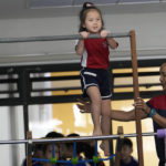
              Rylae-Ann Poulin attends physical education class at Ruamrudee International School in Bangkok, Thailand, Friday, Jan. 13, 2023. The extremely rare AADC deficiency disorder afflicts about 135 children worldwide, many in Taiwan. Judy Wei, who was born in Taiwan, and her husband Richard Poulin III, sought out a doctor there who correctly diagnosed Rylae-Ann. They learned she could qualify for a gene therapy clinical trial in Taiwan. (AP Photo/Sakchai Lalit)
            