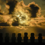 
              Moai statues are silhouetted against a sunrise on Ahu Tongariki, Rapa Nui, or Easter Island, Chile, Saturday, Nov. 26, 2022. Each monolithic human figure carved centuries ago by this remote Pacific island's Rapanui people represents an ancestor. (AP Photo/Esteban Felix)
            