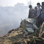 
              Nepalese rescue workers and civilians gather around the wreckage of a passenger plane that crashed in Pokhara, Nepal, Sunday, Jan. 15, 2023. Authorities in Nepal said 68 people have been confirmed dead after a regional passenger plane with 72 aboard crashed into a gorge while landing at a newly opened airport in the resort town of Pokhara. It's the country's deadliest airplane accident in three decades. (AP Photo/Krishna Mani Baral)
            