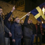 People set on fire a Sweden flag during a small protest outside the Swedish consulate in Istanbul, Turkey, Saturday, Jan. 21, 2023. Turkey on Saturday canceled a planned visit by Sweden's defense minister in response to anti-Turkish protests that increased tension between the two countries as Sweden seeks Turkey's approval to join NATO. (AP Photo/Emrah Gurel)