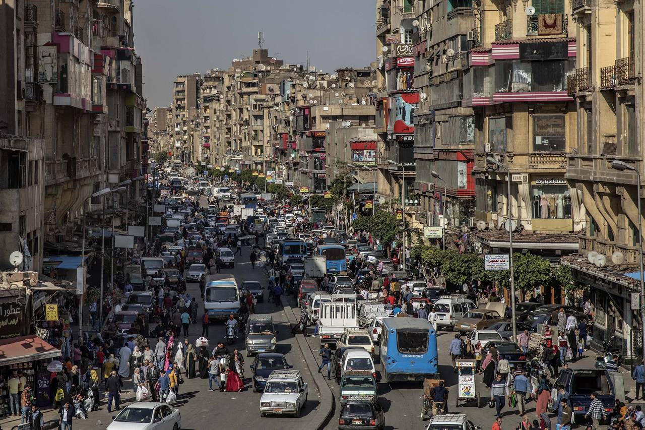 FILE - People crowd a street a few hours ahead of curfew in Cairo, Egypt, Tuesday, April 14, 2020. ...