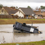 
              A camping trailer sits in a retention pond where a tornado was reported to pass along Mickey Gilley Blvd., near Fairmont Parkway, Tuesday, Jan. 24, 2023, in Pasadena, Texas. (Mark Mulligan/Houston Chronicle via AP)
            