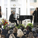 
              Alanis Morissette, right, and Mike Farrell perform during a memorial service for Lisa Marie Presley Sunday, Jan. 22, 2023, in Memphis, Tenn. She died Jan. 12 after being hospitalized for a medical emergency and was buried on the property next to her son Benjamin Keough, and near her father Elvis Presley and his two parents. (AP Photo/John Amis)
            