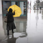 
              A woman battles the wind with her umbrella during a downpour along Grand Avenue on Monday, Jan. 9, 2023, in Los Angeles. (David Crane/The Orange County Register via AP)
            