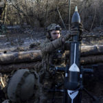 
              A Ukrainian serviceman prepares to fire a 120 mm mortar towards Russian positions at the frontline near Bakhmut, Donetsk region, Ukraine, Wednesday, Jan. 11, 2023. (AP Photo/Evgeniy Maloletka)
            