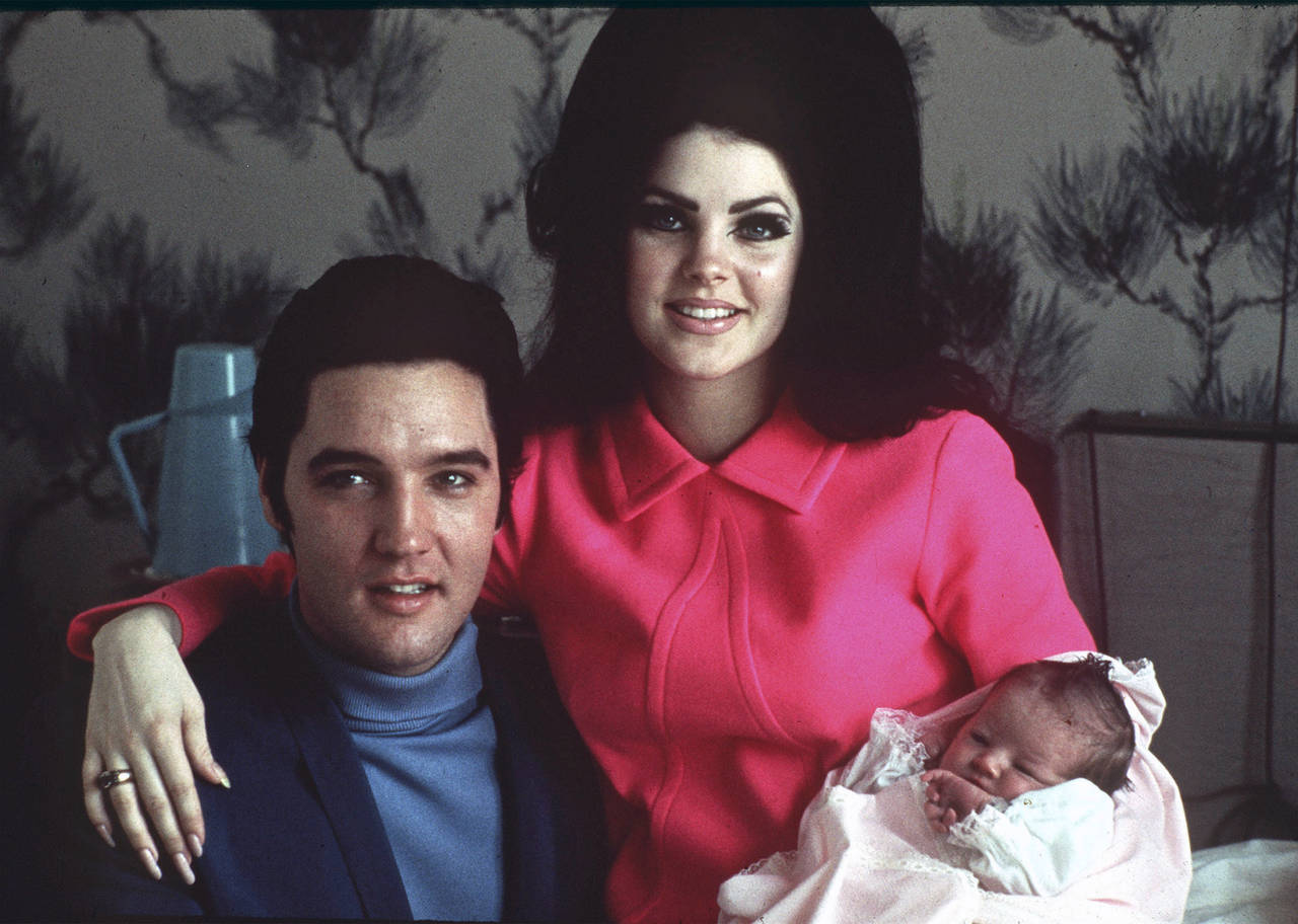 FILE -Elvis Presley poses with wife Priscilla and daughter Lisa Marie, in a room at Baptist hospita...
