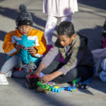 
              Two migrant kids play with donated toys while camping outside the Sacred Heart Church in downtown El Paso, Texas, Sunday, Jan. 8, 2023. President Joe Biden arrived in Texas on Sunday for his first trip to the U.S.-Mexico border since taking office, stopping in El Paso after two years of hounding by Republicans who have hammered him as soft on border security while the number of migrants crossing spirals. (AP Photo/Andres Leighton)
            