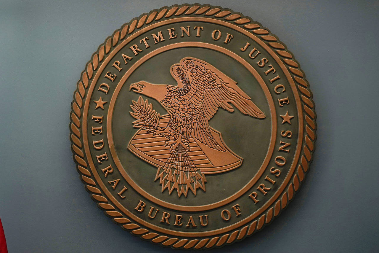 FILE - The seal for the Federal Bureau of Prisons is seen at Federal Bureau of Prisons headquarters...