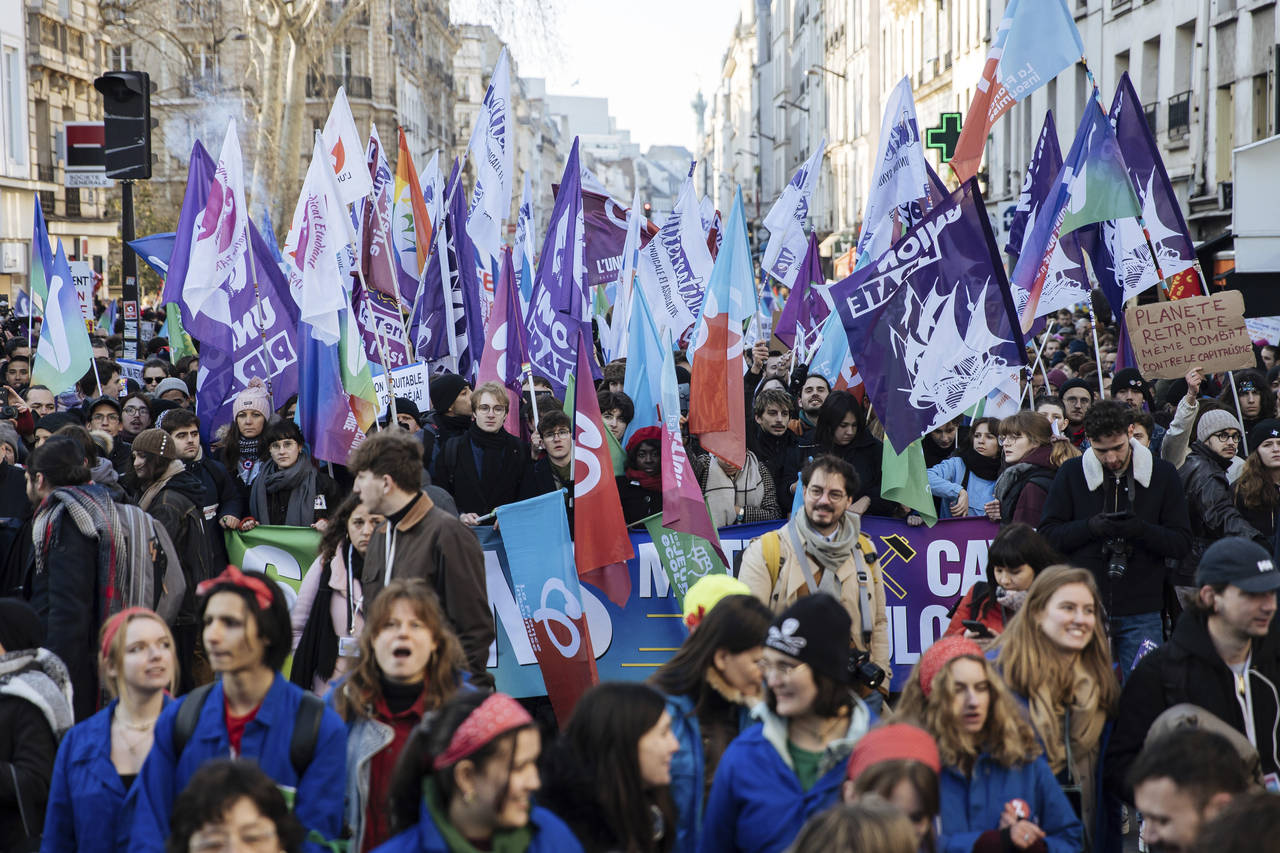Protestors wave flags during a rally, called by left-wing La France Insoumise (LFI) party and Youth...