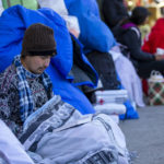 
              A migrant reads the Bible while camping outside the Sacred Heart Church in downtown El Paso, Texas, Sunday, Jan. 8, 2023. President Joe Biden arrived in Texas on Sunday for his first trip to the U.S.-Mexico border since taking office, stopping in El Paso after two years of hounding by Republicans who have hammered him as soft on border security while the number of migrants crossing spirals. (AP Photo/Andres Leighton)
            