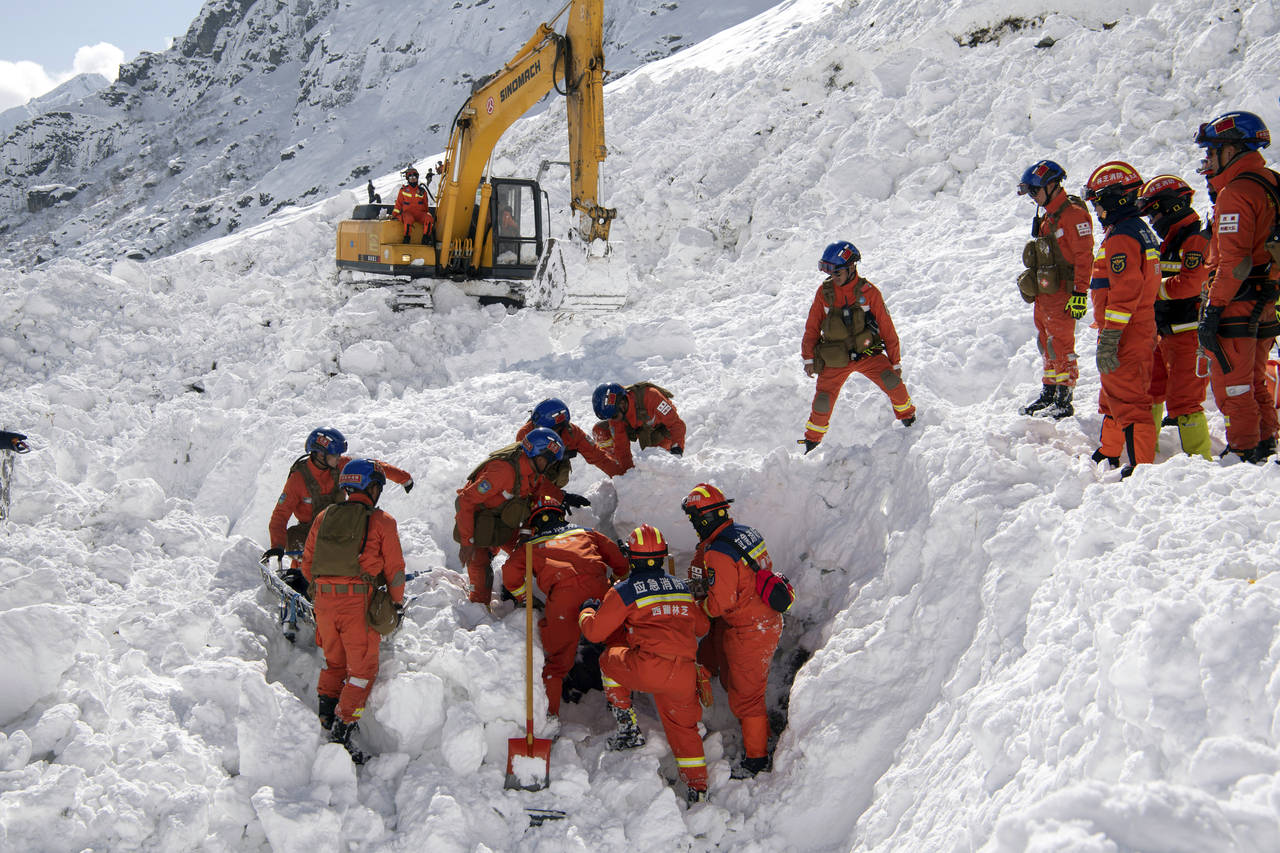 In this photo released by Xinhua News Agency, Rescuers search for survivors following an avalanche ...