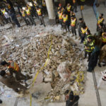 
              Rescue workers gather as they conduct an operation to clear the rubble and find the bodies at the site of Monday's suicide bombing, in Peshawar, Pakistan, Tuesday, Jan. 31, 2023. The death toll from the previous day's suicide bombing at a mosque in northwestern Pakistani rose to more than 85 on Tuesday, officials said. The assault on a Sunni Mosque inside a major police facility was one of the deadliest attacks on Pakistani security forces in recent years. (AP Photo/Muhammad Zubair)
            