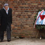 
              Holocaust survivor, Stanislaw Zalewski, attends a wreath lying ceremony in front of the Death Wall in the former Nazi German concentration and extermination camp Auschwitz during ceremonies marking the 78th anniversary of the liberation of the camp in Oswiecim, Poland, Friday, Jan. 27, 2023. (AP Photo/Michal Dyjuk)
            