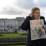 
              A journalist holds up a copy of a UK newspaper as she reports outside Buckingham Palace in London, Monday, Jan. 9, 2023. Prince Harry has defended his memoir that lays bare rifts inside Britain's royal family. He says in TV interviews broadcast Sunday that he wanted to "own my story" after 38 years of "spin and distortion" by others. Harry's soul-baring new memoir, "Spare," has generated incendiary headlines even before its release. (AP Photo/Kirsty Wigglesworth)
            