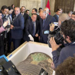 Foreign Minister Sameh Shoukry, center right, and Mostafa Waziri, top official at the Supreme Council of Antiquities, talk in front of an ancient wooden sarcophagus during a handover ceremony at the foreign ministry in Cairo, Egypt, Monday, Jan. 2, 2023. An ancient wooden sarcophagus that was featured at the Houston Museum of Natural Sciences was returned to Egypt after U.S. authorities determined it was looted years ago, Egyptian officials said Monday. (AP Photo/Mohamed Salah)
