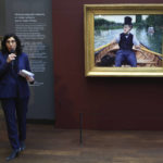 
              French Culture Minister Rima Abdul-Malaki speaks beside "A Boating Party" by French painter Gustave Caillebotte at the Orsay Museum, Monday, Jan. 30, 2023 in Paris. France has acquired a stunning Impressionist masterpiece for its national collection of art treasures, with luxury goods giant LVMH helping to pay 43-million euros (nearly $47 million) for "A Boating Party" by 19th century French artist Gustave Caillebotte. (AP Photo/Aurelien Morissard)
            