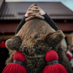 
              A boy wearing a bear fur costume waits for the start of a parade showcasing regional winter traditions in Comanesti, northeastern Romania, Friday, Dec. 30, 2022. Every year on Dec. 30 bear hundreds of people dressed as bears, from toddlers to adults, fill the main street growling as they dance or jokingly simulating aggressive moves towards the many onlookers. (AP Photo/Andreea Alexandru)
            