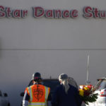 
              Two men walk to the Star Ballroom Dance Studio holding flowers on Monday, Jan. 23, 2023, in Monterey Park, Calif. A gunman killed multiple people at the ballroom dance studio late Saturday amid Lunar New Year's celebrations in the predominantly Asian American community. (AP Photo/Ashley Landis)
            