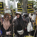 
              Muslim protesters shout slogans during a rally outside the Swedish Embassy in Jakarta, Indonesia, Monday, Jan. 30, 2023. Hundreds of Indonesian Muslims marched to the heavily guarded Swedish Embassy in the country's capital on Monday to denounce the recent desecration of Islam's holy book by far-right activists in Sweden and the Netherlands. (AP Photo/Tatan Syuflana)
            