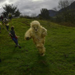 
              A member of the carnival group 'La Vijanera de Silio', who represents the role of a wild bear, runs during the traditional ancient festival in the town of Silio, northern Spain, Saturday, Jan. 7, 2023. The clanging of cowbells as dawn breaks in a remote Spanish village is nothing other than the restoration of the cosmic order with the return of an ancient winter festival. (AP Photo/Alvaro Barrientos)
            