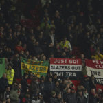 
              Manchester United fans hold up banners against the current owners of the club the Glazers, just ahead of the start of the English League Cup 4th round soccer match between Manchester United and Burnley, at Old Trafford in Manchester, England Wednesday, Dec. 21, 2022. (AP Photo/Dave Thompson)
            