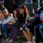 
              People wait in a park to be called on by the nearby U.S. embassy on the day of its reopening for visa and consular services in Havana, Cuba, Wednesday, Jan. 4, 2023. (AP Photo/Ismael Francisco)
            