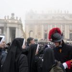 
              Faithful arrive into St. Peter's Square at the Vatican, ahead of the funeral mass for late Pope Emeritus Benedict XVI, Thursday, Jan. 5, 2023. Benedict died at 95 on Dec. 31 in the monastery on the Vatican grounds where he had spent nearly all of his decade in retirement, his days mainly devoted to prayer and reflection. (AP Photo/Gregorio Borgia)
            