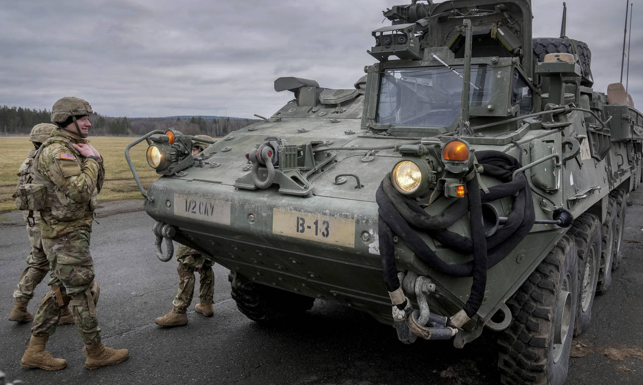 FILE - Soldiers of the 2nd Cavalry Regiment stand next to a Stryker combat vehicle in Vilseck, Germ...