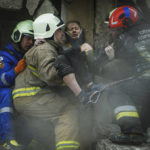
              In this photo released by State Emergency Service of Ukraine on Monday, Jan. 16, 2022, Ukrainian State Emergency Service firefighters carry a wounded woman out of the rubble from a building after a Russian rocket attack on Saturday in Dnipro, Ukraine, Sunday, Jan. 15, 2023. (Pavel Petrov, SESU via AP)
            